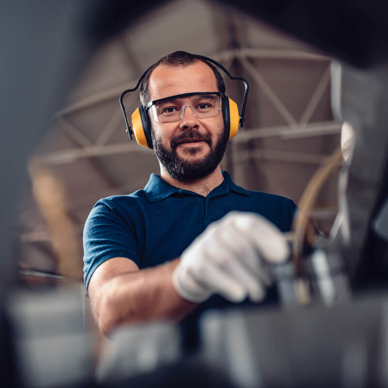 Safety employee performing an onsite safety audit in protective gear.