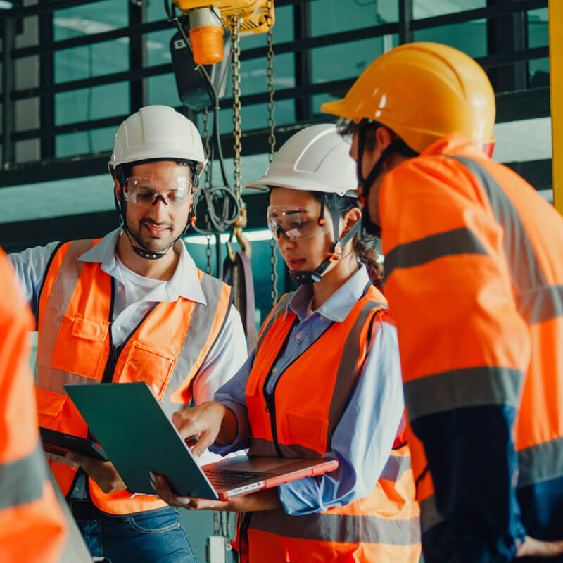 Employees in safety gear performing an onsite safety audit.