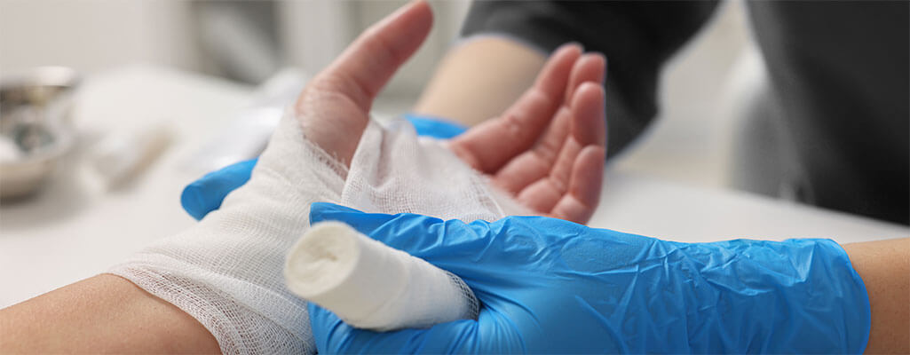 Nurse tending to a patient's hand