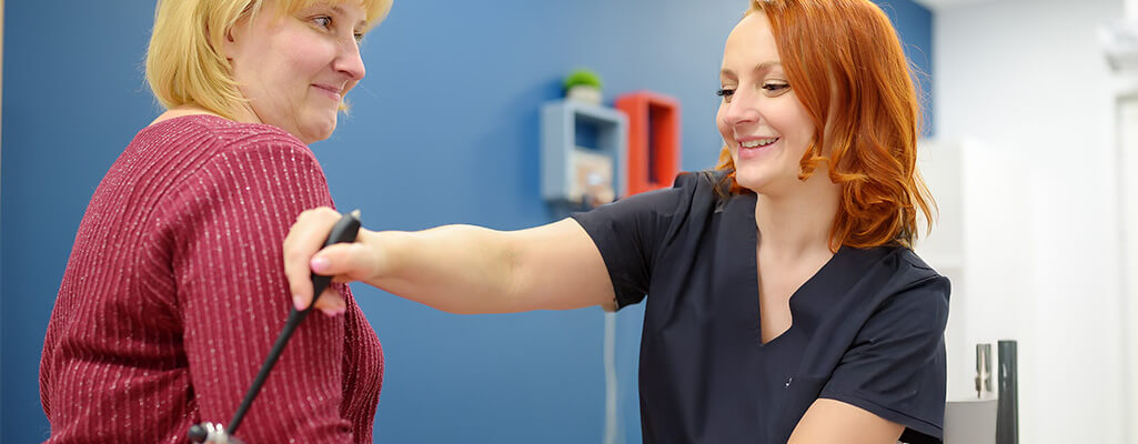 Nurse checking patient's vitals.