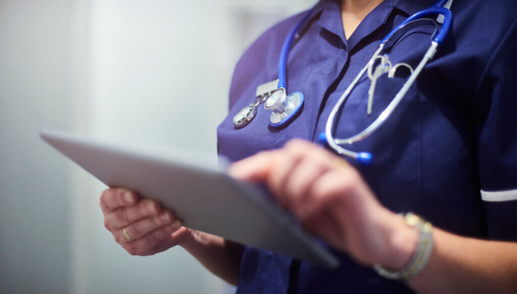nurse reading clipboard