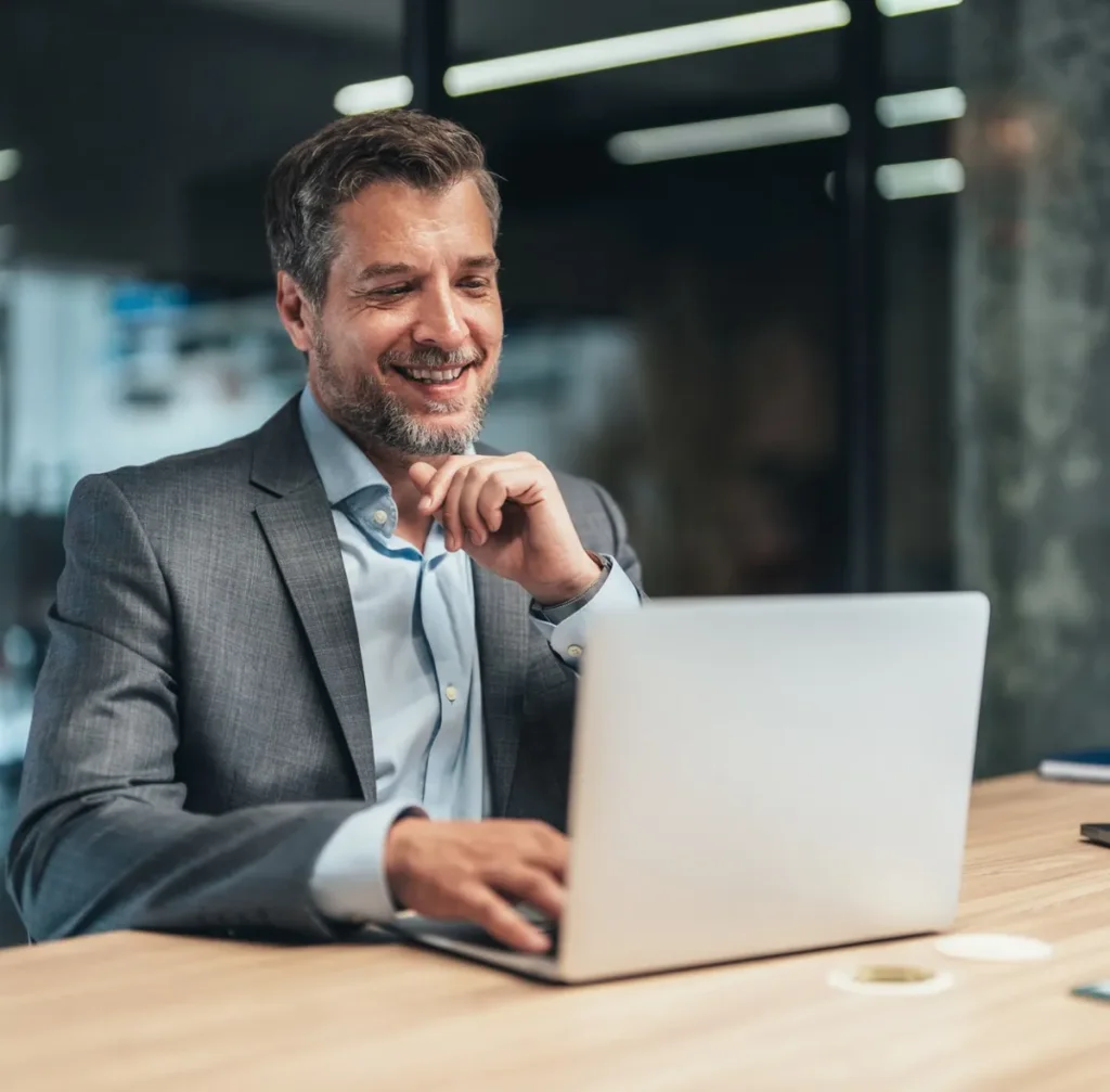 Business professional working on laptop in office environment