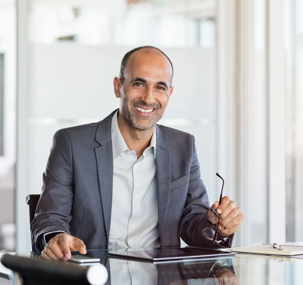 Employee working on laptop reviewing documents in office environment