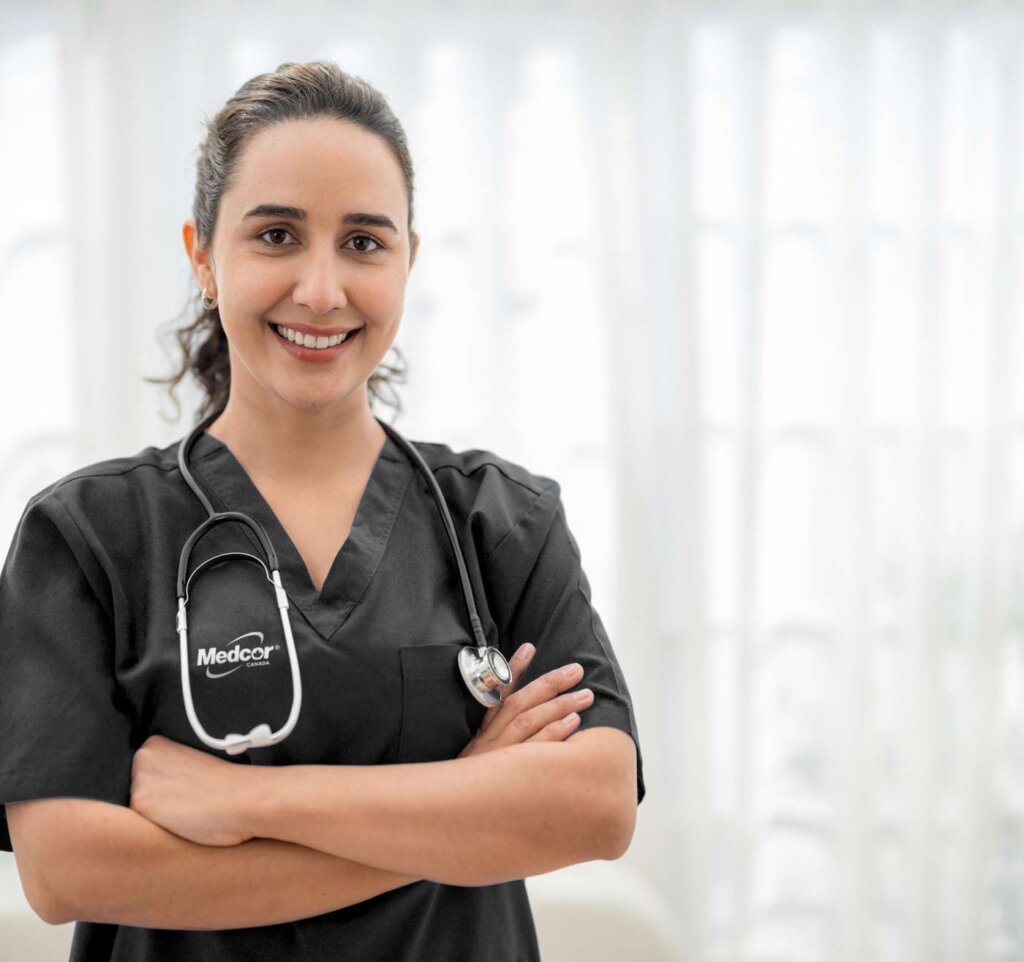 clinic clinical expertise Medcor Canada nurse with stethoscope smiling with arms crossed