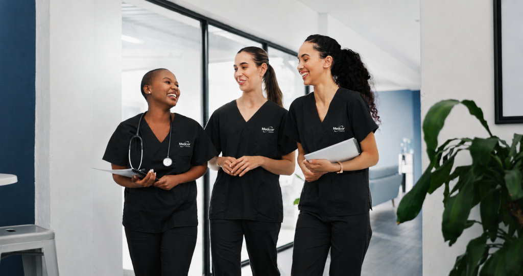 Medcor Canada clinic nurses walking through modern healthcare facility in black Medcor scrubs